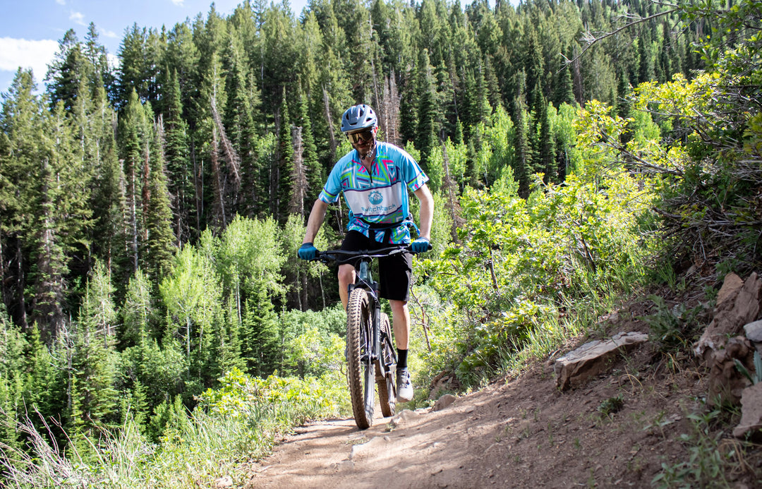 Guy mountain biking in Park City on a bike rental from Switchback Sports